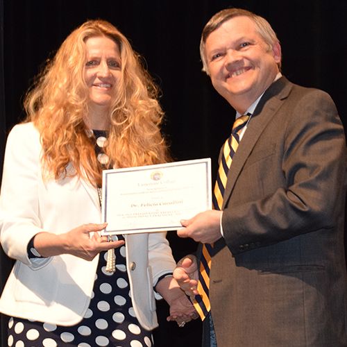 Dr. Felicia Cavallini receives an award from President Parker