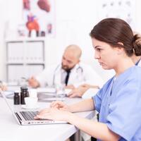 Medical practitoner working on laptop