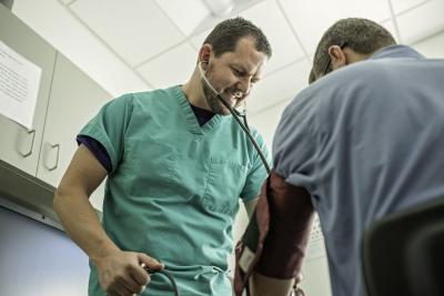 nurse checking blood pressure