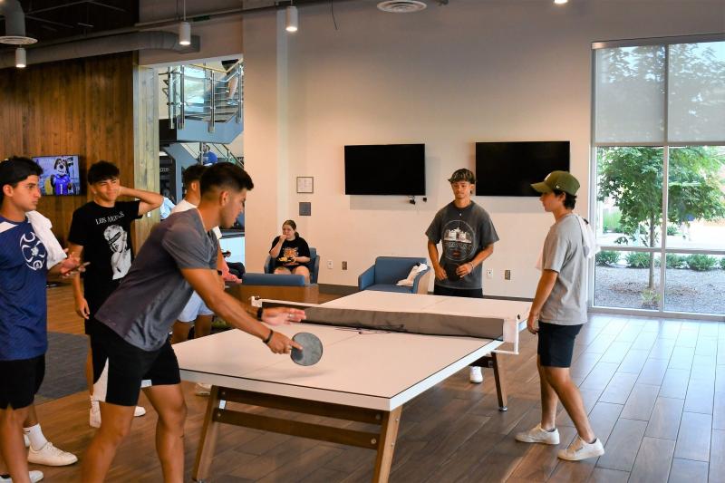 Students playing ping pong in Hines and Riggins Center