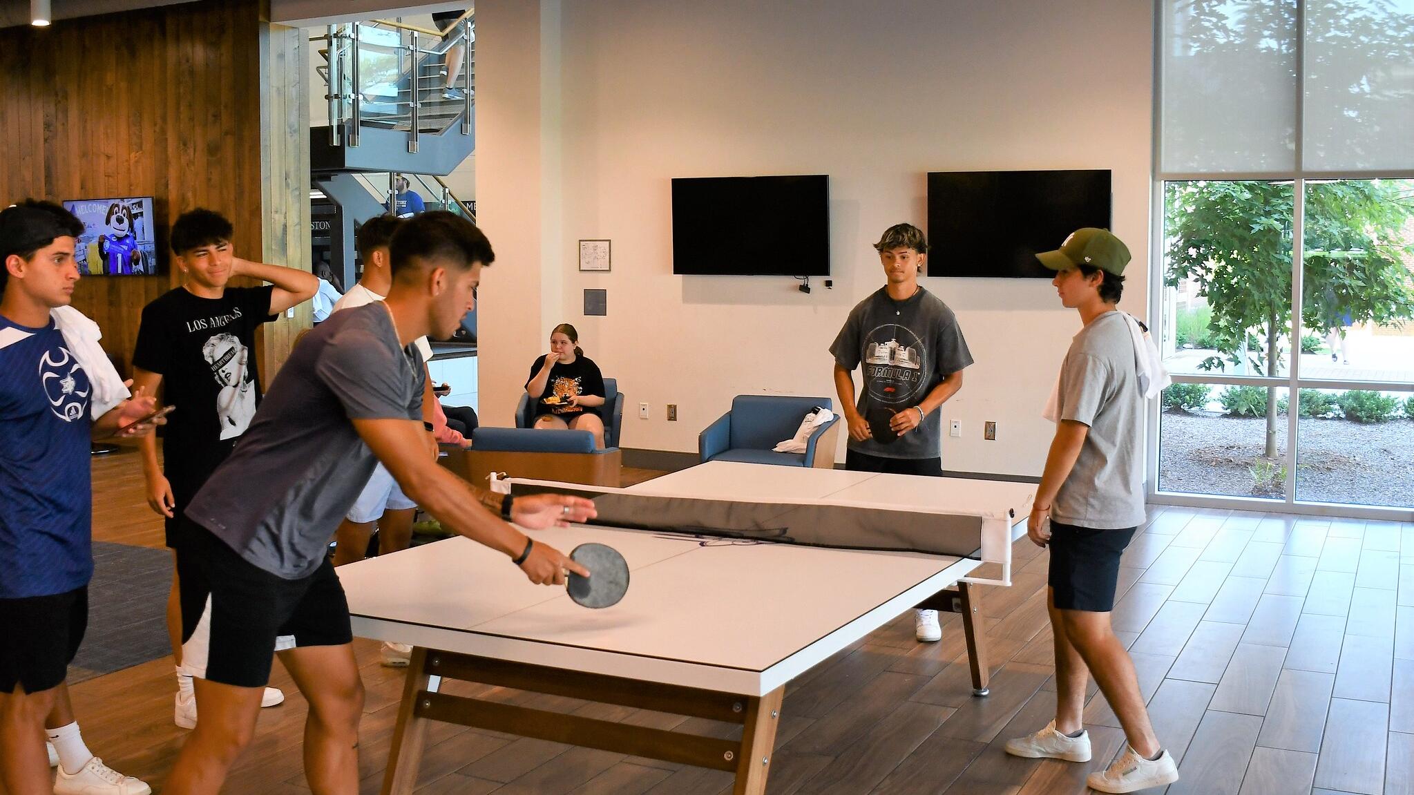 Students playing ping pong in Hines and Riggins Center