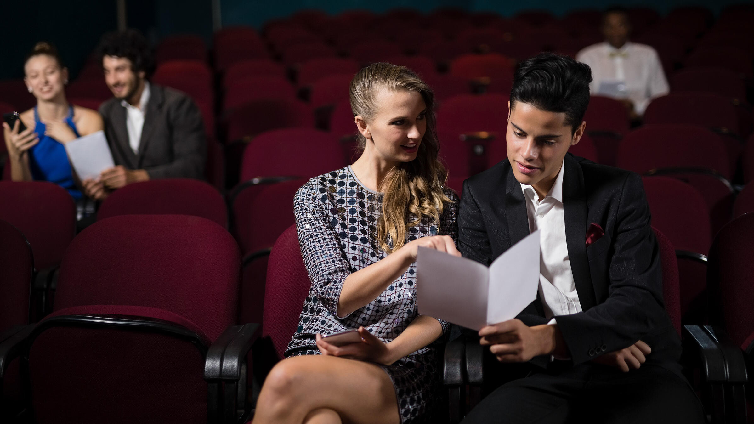 couple reading in theatre