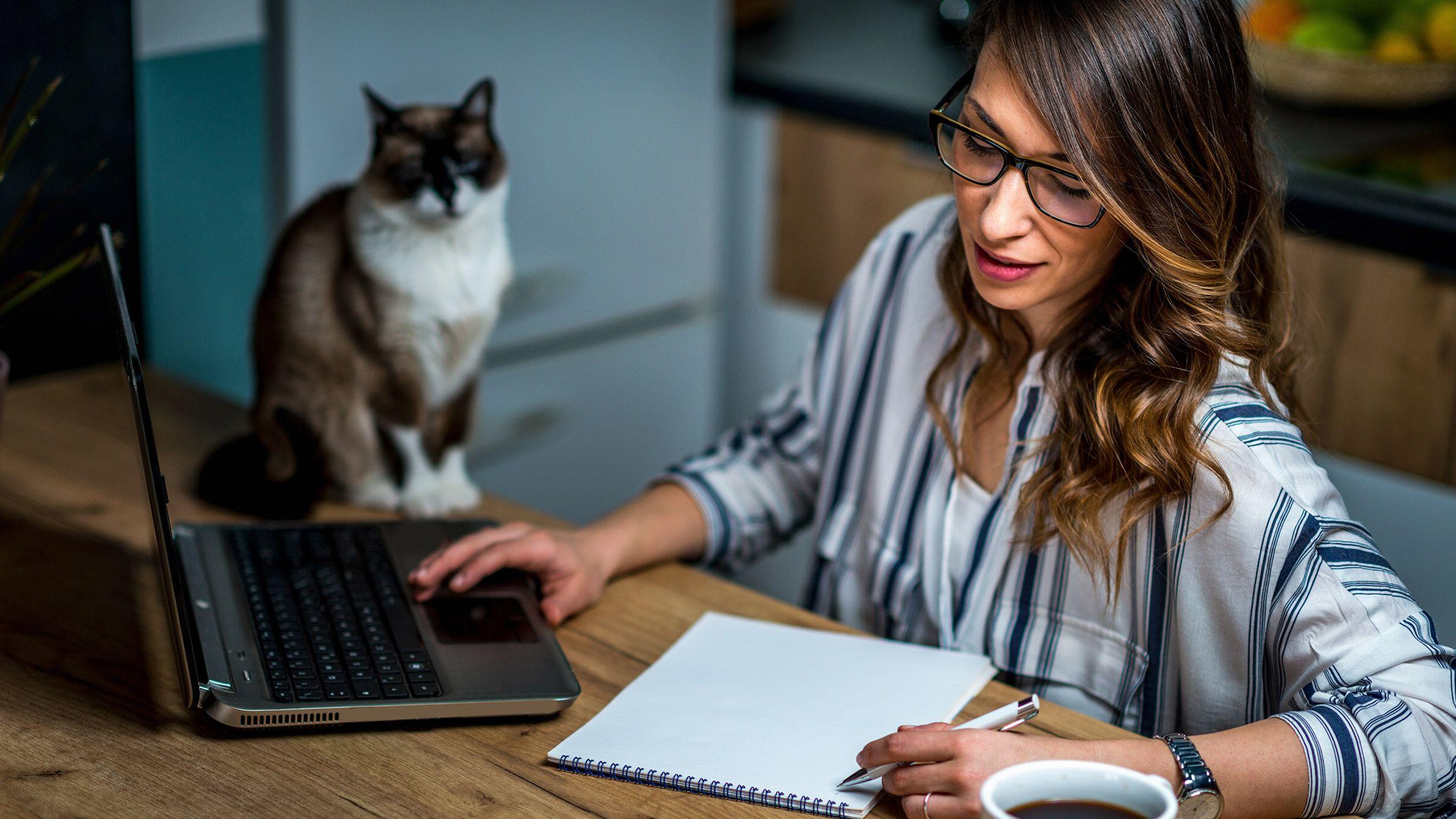 young-woman-drinking-coffee-and-working-at-home