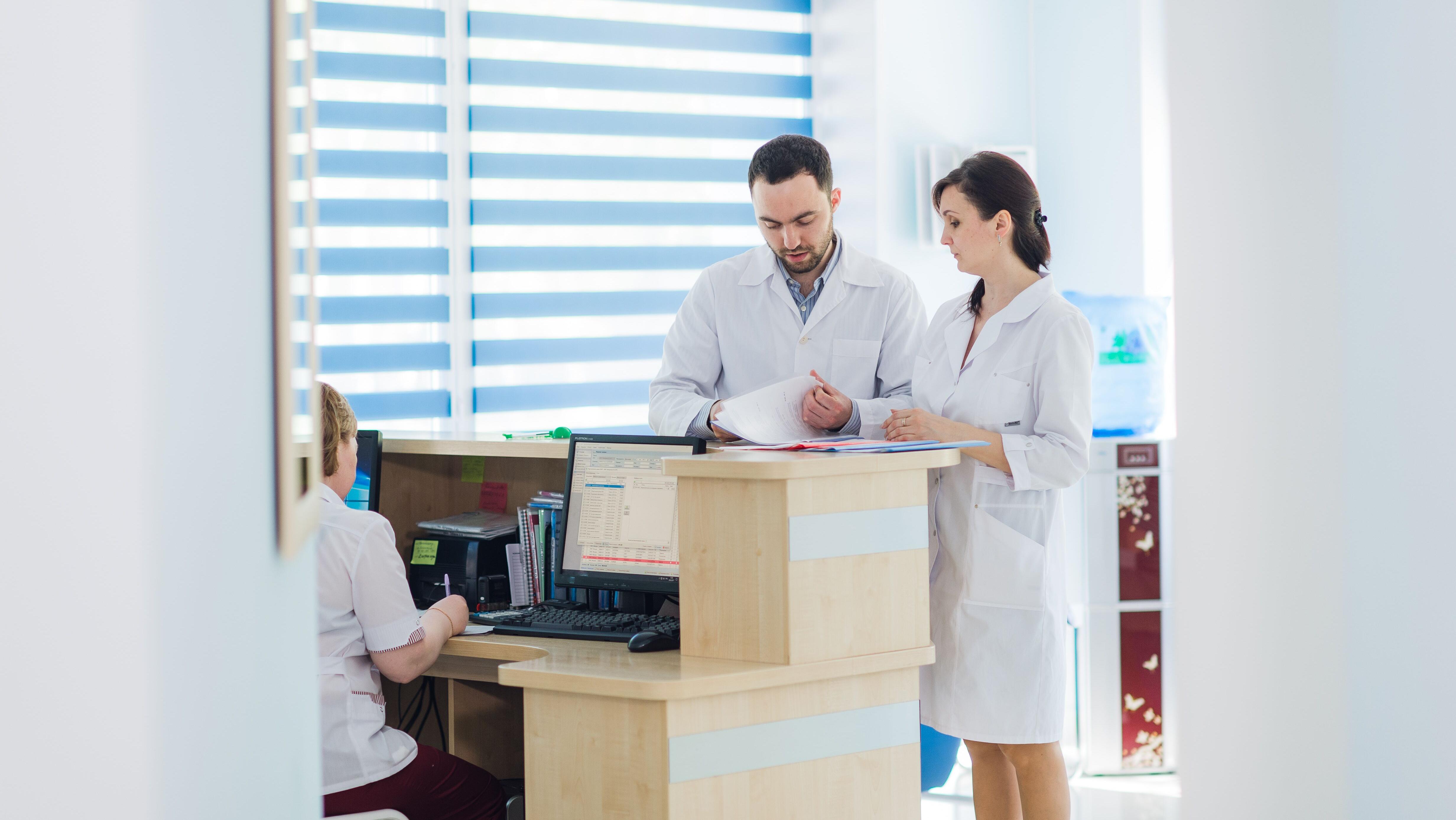 Busy reception in a hospital with doctors and receptionists