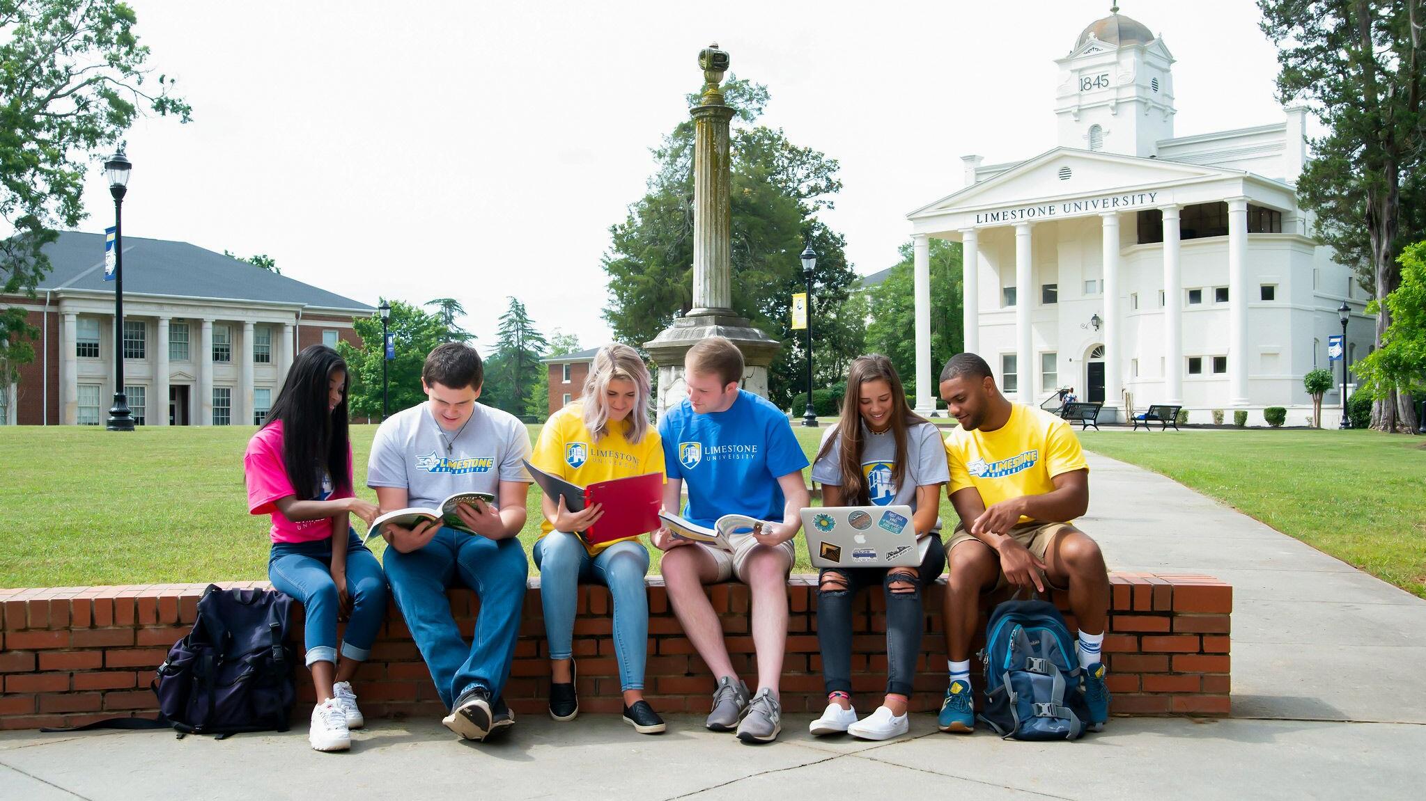 Students on front quad students sitting on brick