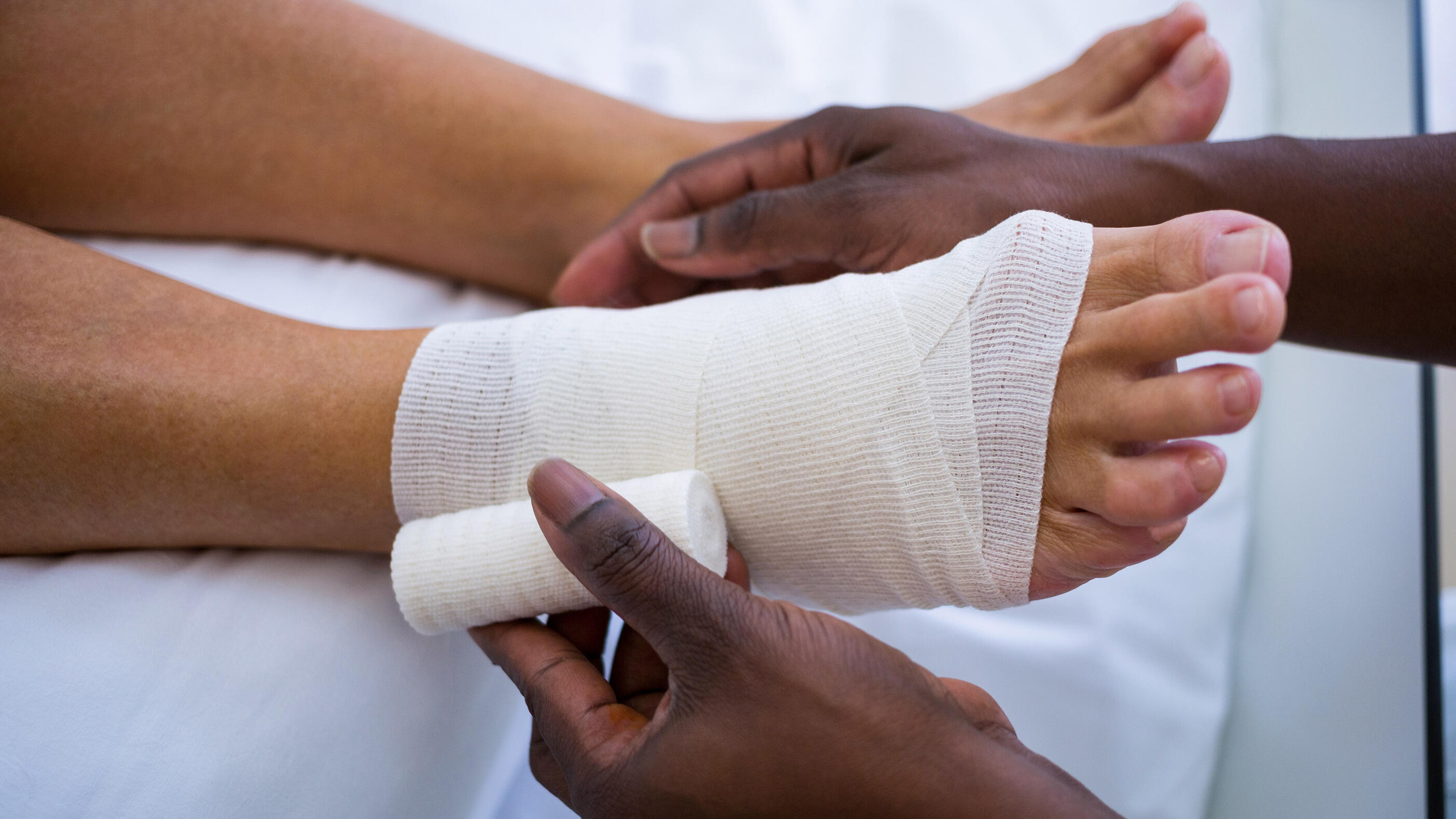 Doctor bandaging patients leg