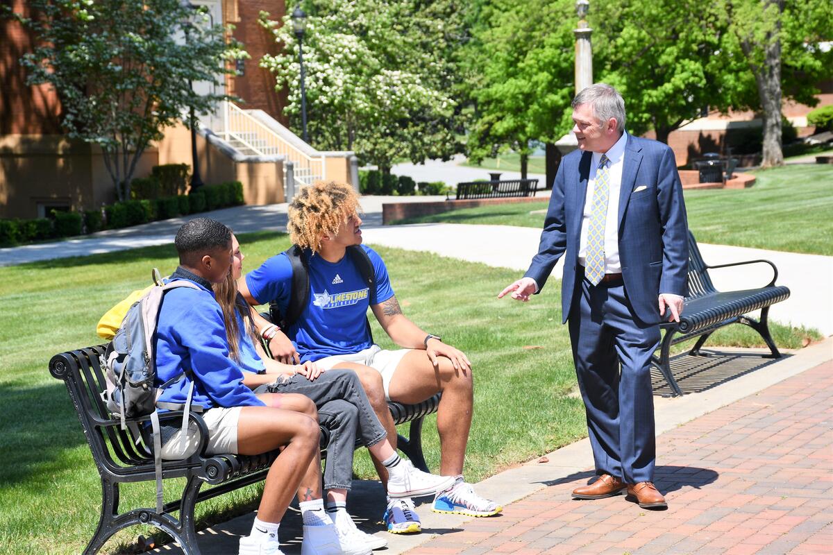 Dr. Parker with students on front campus