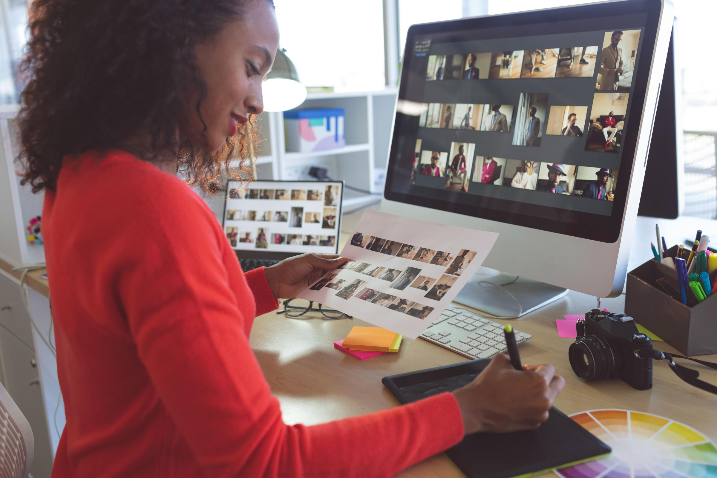 Female graphic designer writing on tablet in a modern office