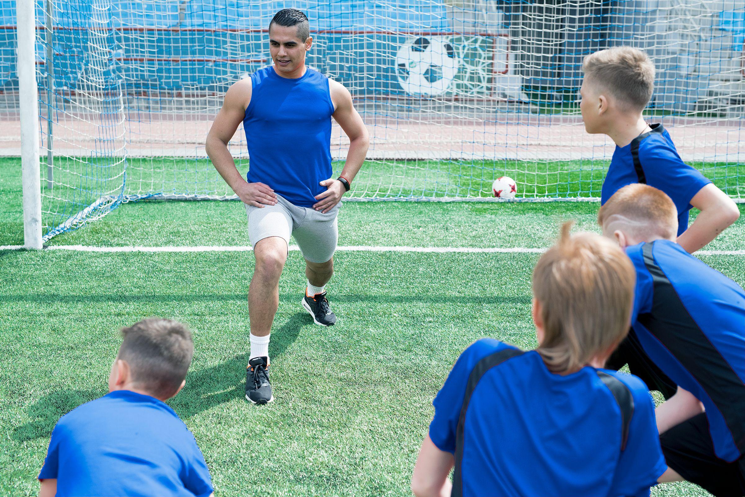 Soccer coach showing exercise - physical education - teacher